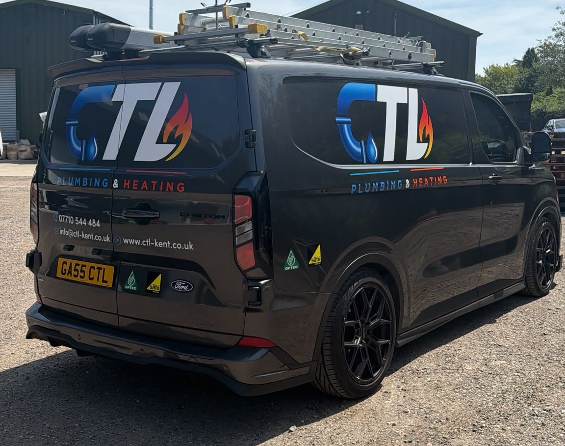 Rear three-quarter view of the black wrapped CTL Plumbing & Heating van, showing the phone number, email and website